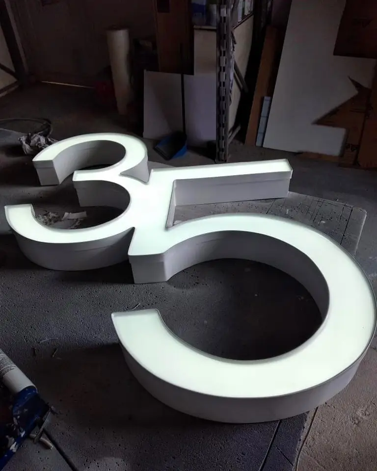 Custom illuminated number sign '35' made of aluminum, acrylic, and automotive paint, crafted by Infinite Crafts in Aruba.