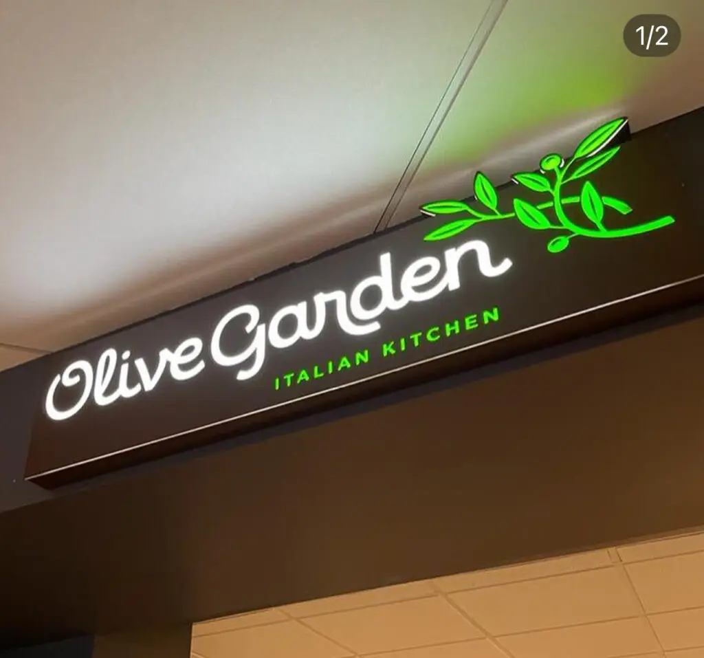 Custom CNC-machined aluminum sign with acrylic, vinyl, and internal illumination for Olive Garden, crafted by Infinite Crafts in Aruba.