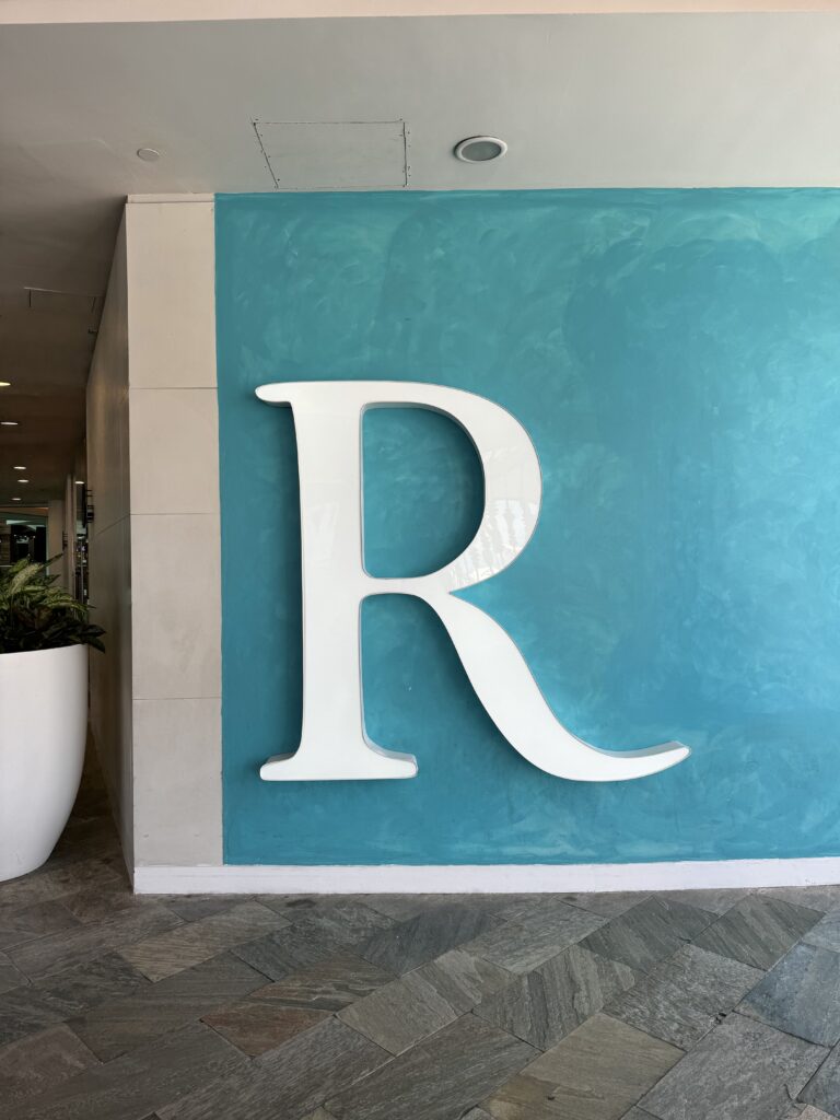 Illuminated Renaissance Hotel 'R' sign crafted by Infinite Crafts in Aruba, featuring bold channel letters with LED lighting.