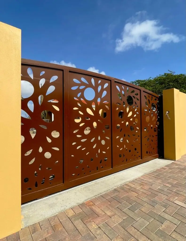 Custom aluminum gate with unique pattern designed in-house by Infinite Crafts in Aruba, combining style and functionality.